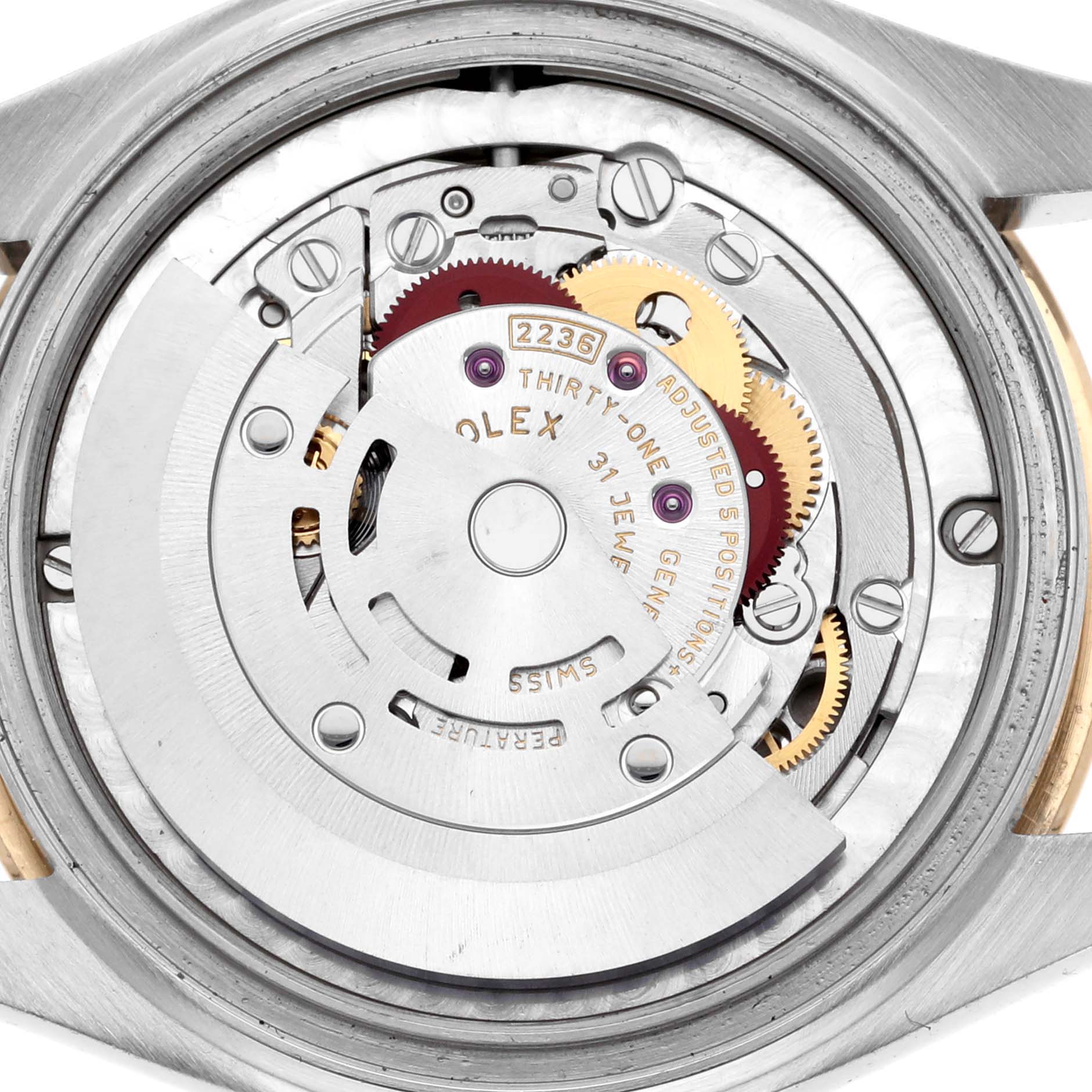 The image shows the movement mechanism of a Rolex Mid-Size 278243 Women's Steel and Gold (two tone) White Dial 278243 Women's Steel and Gold (two tone) White Dial watch from a top-down angle, highlighting its intricate gears and components.