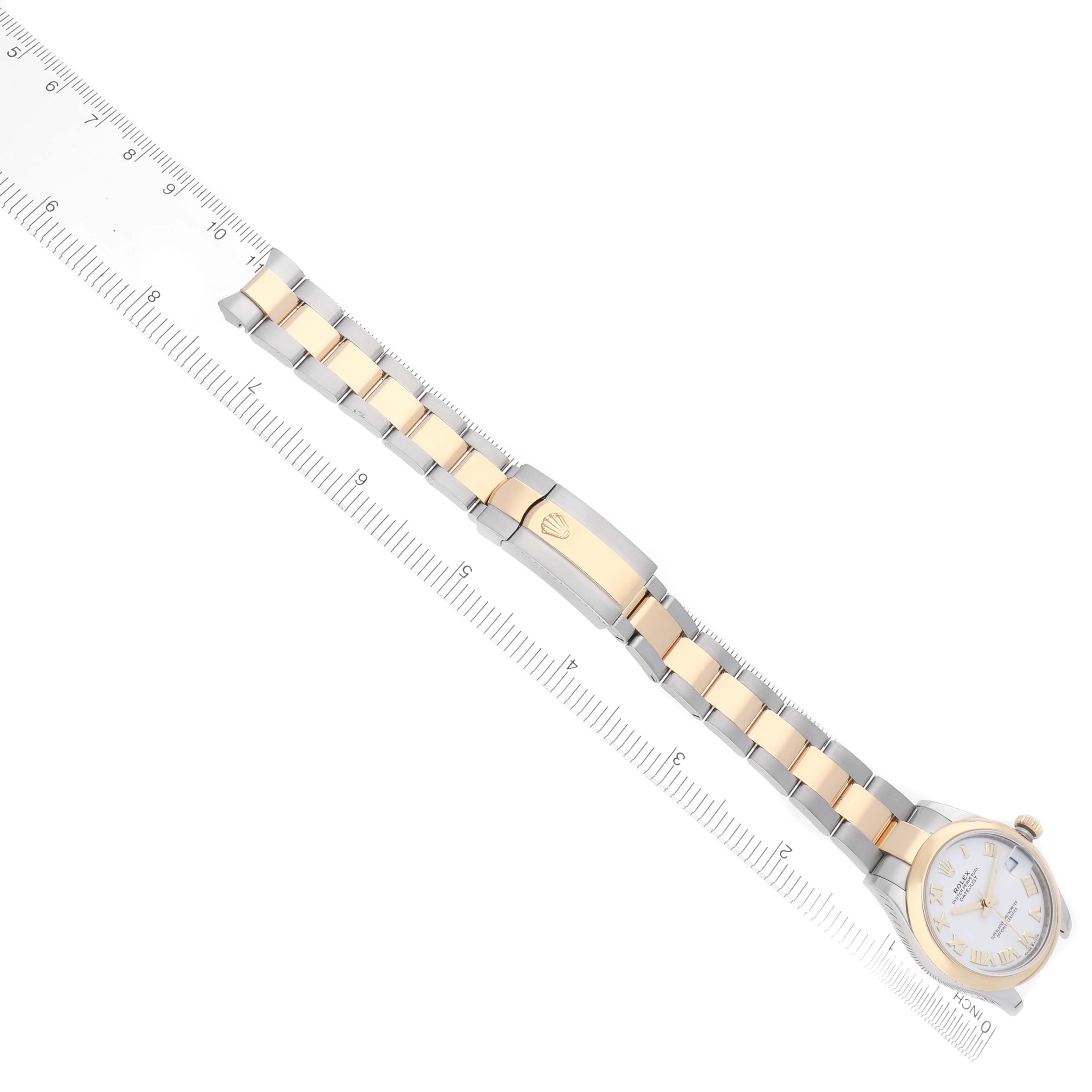 The Rolex Mid-Size 278243 Women's Steel and Gold (two tone) White Dial 278243 Women's Steel and Gold (two tone) White Dial watch is shown at a top view, highlighting the bracelet and clasp alongside a ruler.