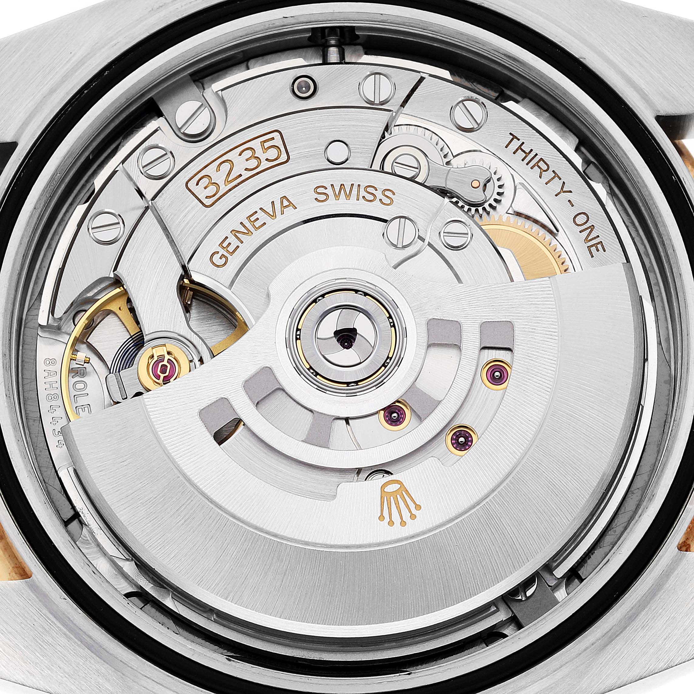 The image shows a close-up view of the movement inside a Rolex Datejust 41 126333 Men's Steel and Gold (two tone) Grey Dial 126333 Men's Steel and Gold (two tone) Grey Dial, highlighting the intricate gears and mechanisms.