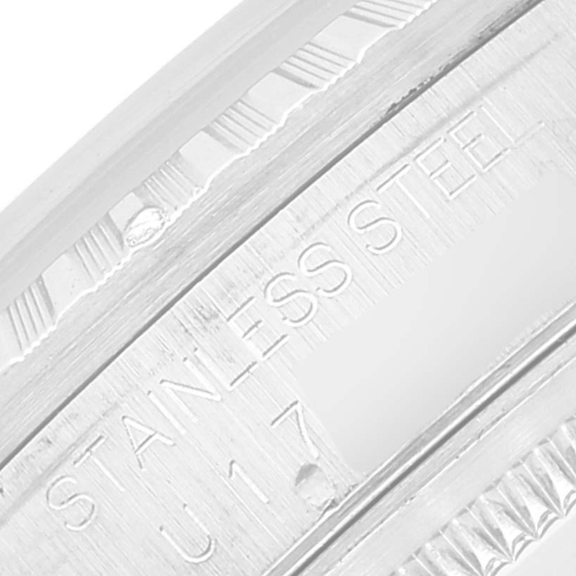 The image shows a close-up of the engraved stainless steel material and serial number on a Rolex Datejust 16220 Men's Stainless Steel Blue Dial 16220 Men's Stainless Steel Blue Dial model.