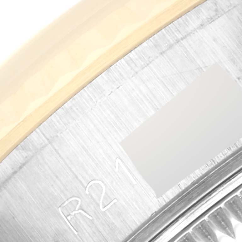 This close-up shows the bezel and part of the case with engravings of a Rolex Datejust 69173 Women's Steel and Gold (two tone) Champagne Dial 69173 Women's Steel and Gold (two tone) Champagne Dial watch.