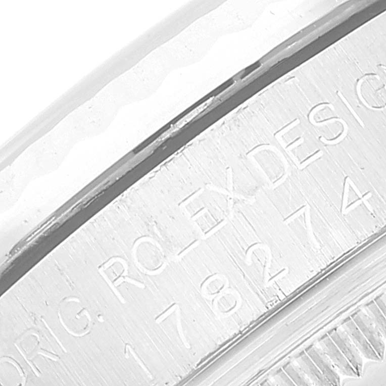This image shows a close-up of the engraved bezel of a Mid-Size Rolex watch, with part of the model number and "ORIG. ROLEX DESIGN" visible.