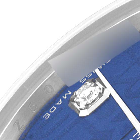 The image shows a close-up angle of a Rolex Mid-Size 178274 Women's Stainless Steel Blue Dial 178274 Women's Stainless Steel Blue Dial watch's dial and bezel, featuring part of a diamond marker.