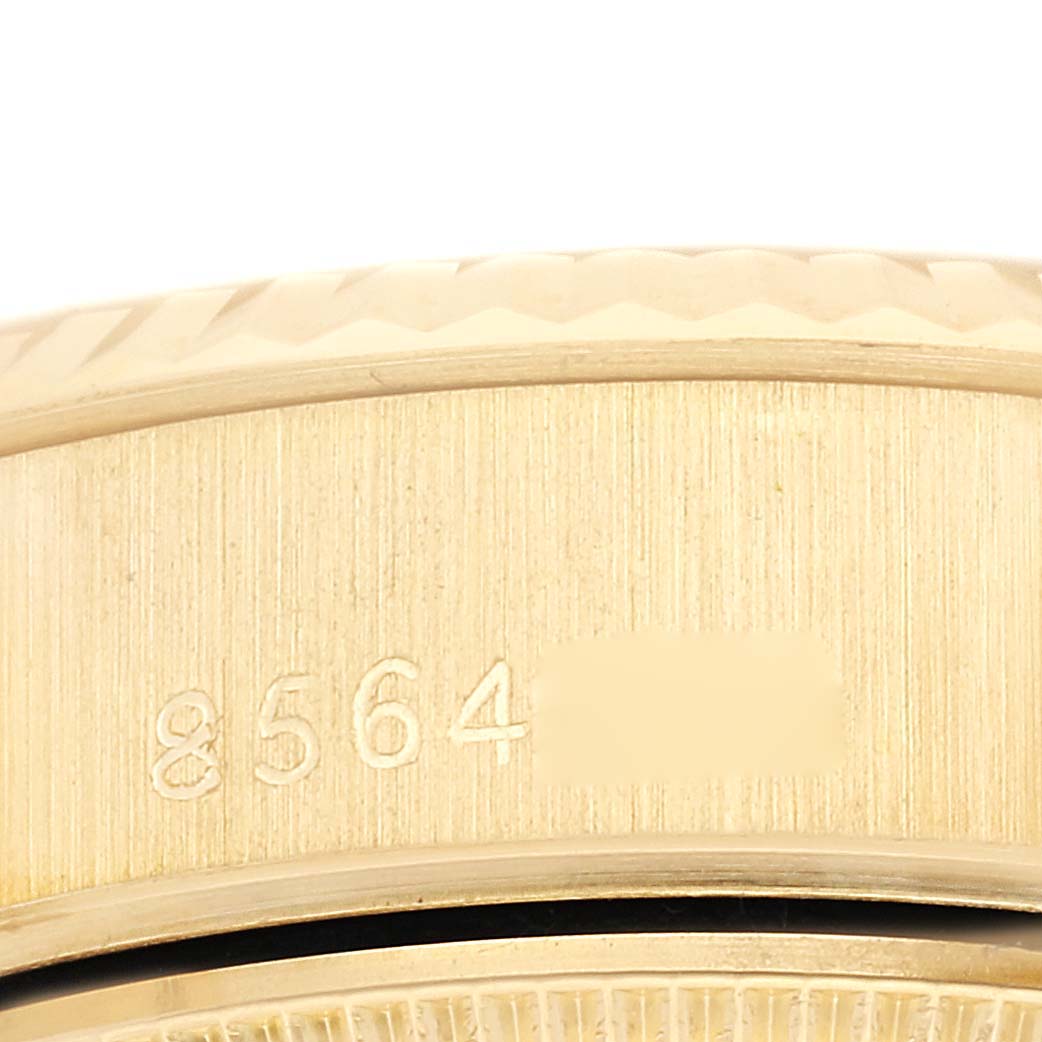 This close-up image shows the serial number and fluted bezel of the Rolex President 69178 Women
s Yellow Gold Champagne Dial 69178 Women
s Yellow Gold Champagne Dial model watch.