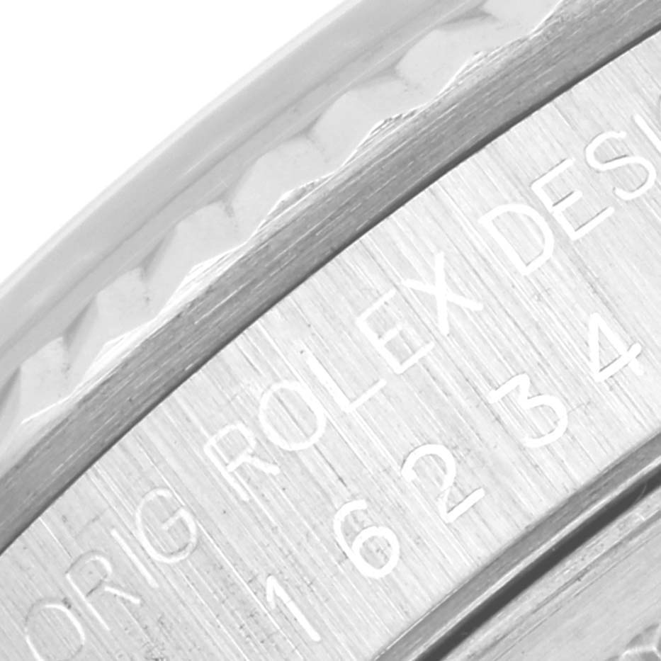 This image shows a close-up of the engraved side of a Rolex Datejust 16234 Men's Stainless Steel Silver Dial 16234 Men's Stainless Steel Silver Dial model's case, specifically indicating its model number.