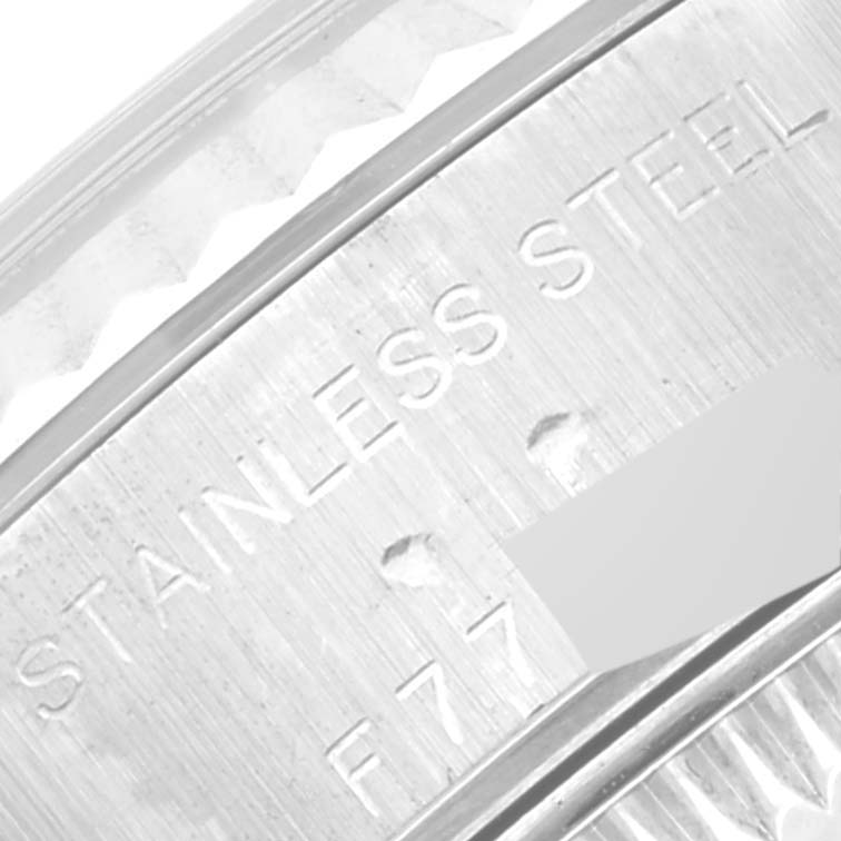 This image shows a close-up of the side view of a Rolex Datejust 79174 Women's Stainless Steel Silver Dial 79174 Women's Stainless Steel Silver Dial watch case, featuring "STAINLESS STEEL" engraving.