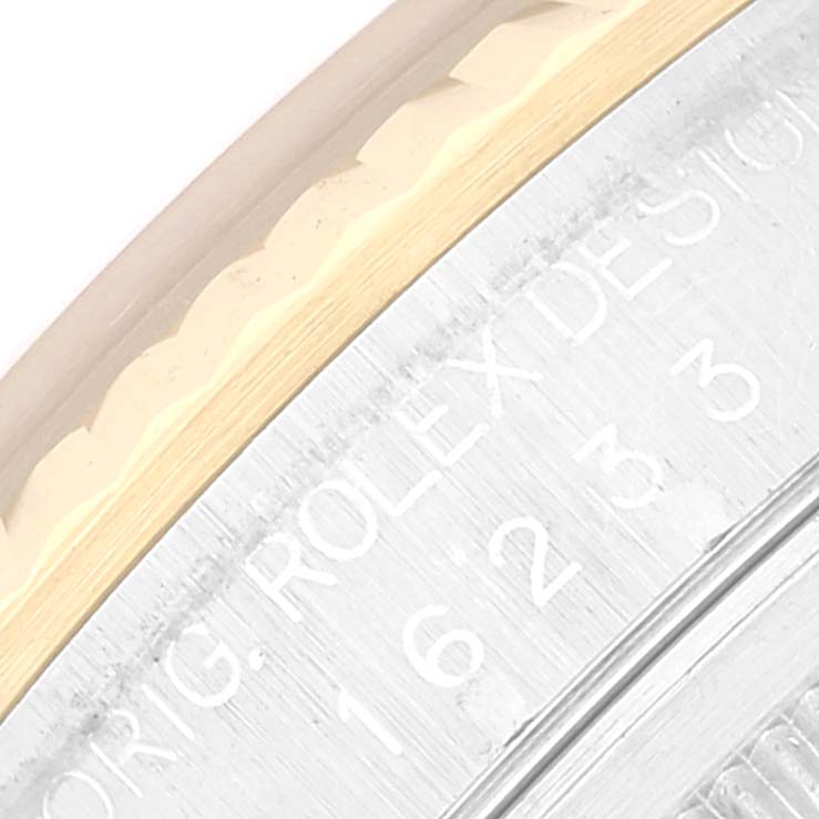 This close-up image shows the rim and part of the engraved back of a Rolex Datejust 16233 Men's Steel and Gold (two tone) Grey Dial 16233 Men's Steel and Gold (two tone) Grey Dial watch.