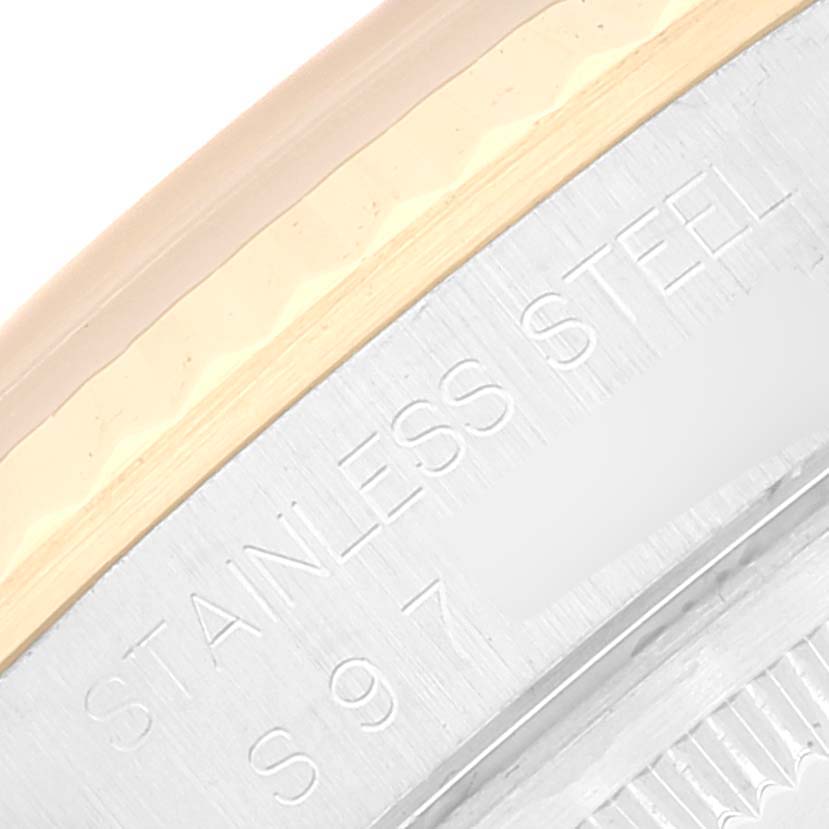 The image shows part of the stainless steel case and bezel edge of a Rolex Datejust 16233 Men's Steel and Gold (two tone) Champagne Dial 16233 Men's Steel and Gold (two tone) Champagne Dial watch.