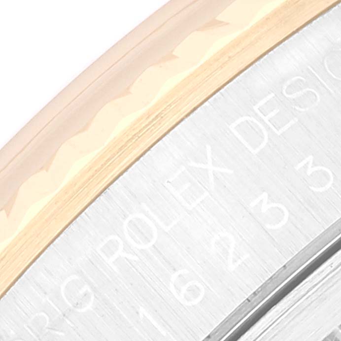 The image shows a close-up of the bezel and part of the dial of a Rolex Datejust 16233 Men's Steel and Gold (two tone) Champagne Dial 16233 Men's Steel and Gold (two tone) Champagne Dial watch.