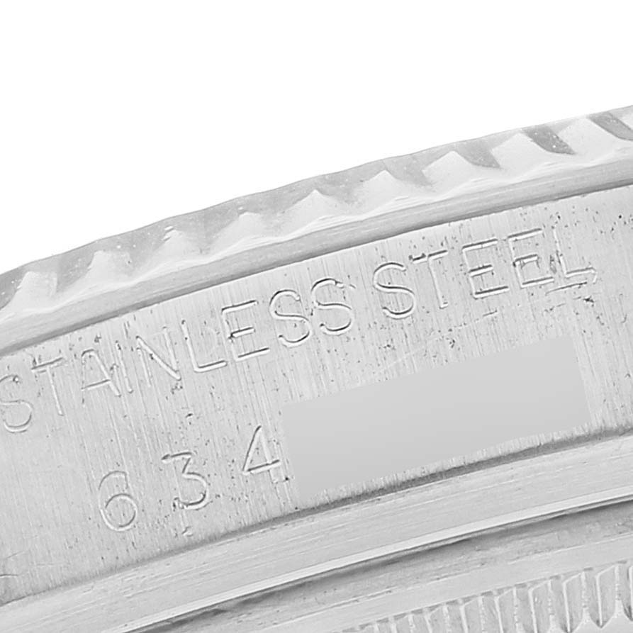 This close-up image shows the engraved text on the bezel of a Rolex Datejust 16014 Men's Stainless Steel Silver Dial 16014 Men's Stainless Steel Silver Dial watch, including "Stainless Steel" and a partial serial number.