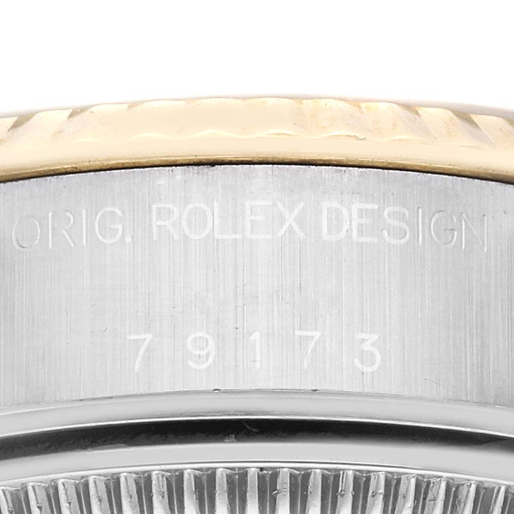 This close-up image shows the case side and part of the bezel of a Rolex Datejust 79173G Women's Steel and Gold (two tone) Champagne Dial 79173G Women's Steel and Gold (two tone) Champagne Dial watch with engraved model number "79173."