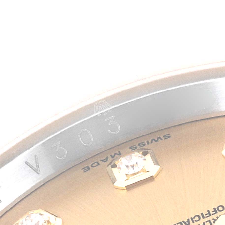 The image shows a close-up angle of the dial and part of the bezel of the Rolex Datejust 116243 Men's Steel and Gold (two tone) Champagne Dial 116243 Men's Steel and Gold (two tone) Champagne Dial watch, with diamond markers and text "SWISS MADE."