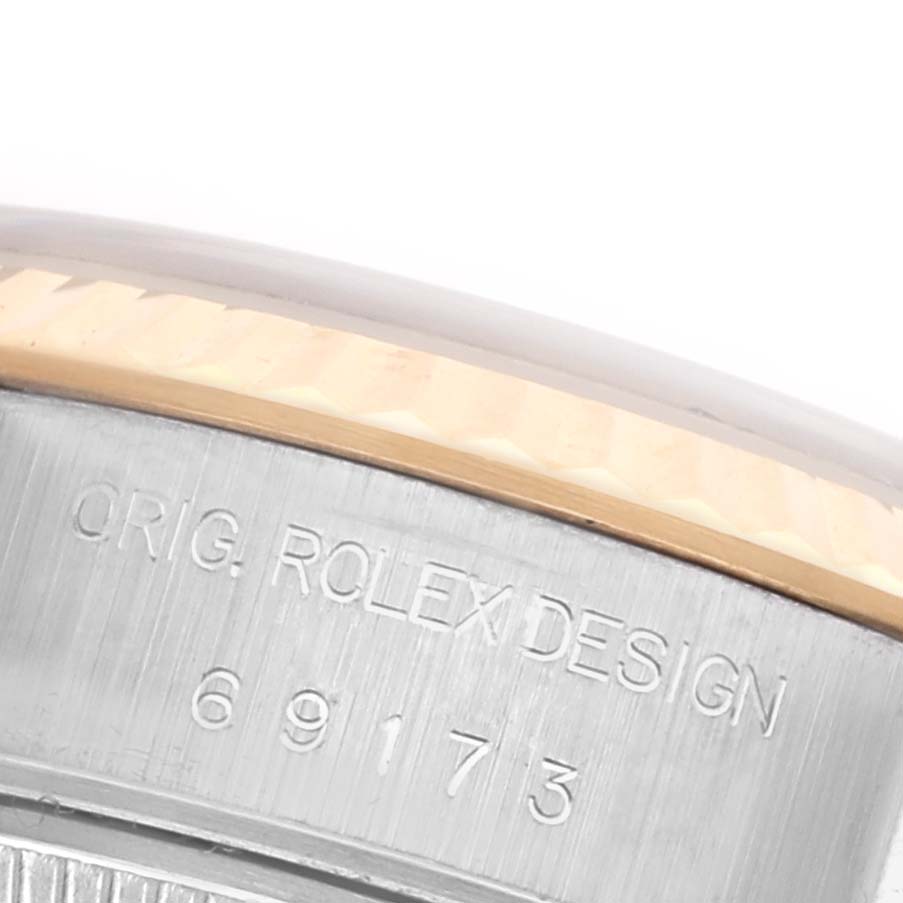 The image shows a close-up of the case side of a Rolex Datejust 69173 Women's Steel and Gold (two tone) Champagne Dial 69173 Women's Steel and Gold (two tone) Champagne Dial, highlighting its model number engraving.