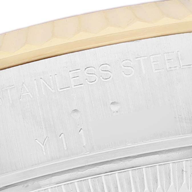 The image shows a close-up of the side of a Rolex Datejust 79173 Women's Steel and Gold (two tone) White Dial 79173 Women's Steel and Gold (two tone) White Dial, highlighting the bezel and part of the case with engraved text.