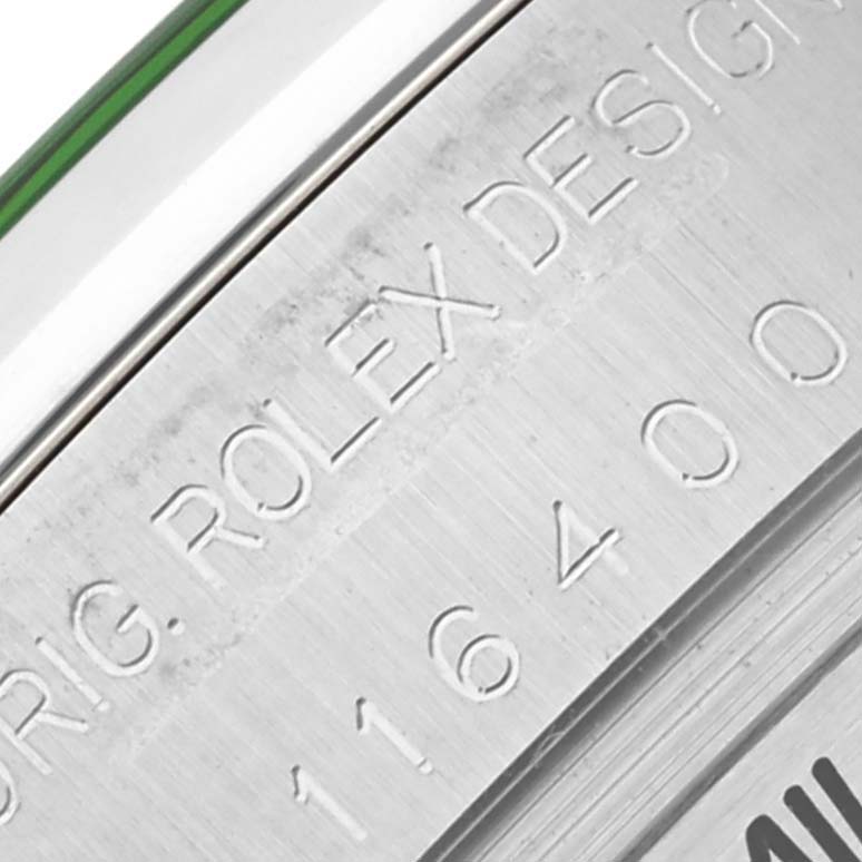 The image shows a close-up of the model number and "ORIG. ROLEX DESIGN" engraving on the side of a Rolex Milgauss 116400GV Men's Stainless Steel Black Dial 116400GV Men's Stainless Steel Black Dial watch case.