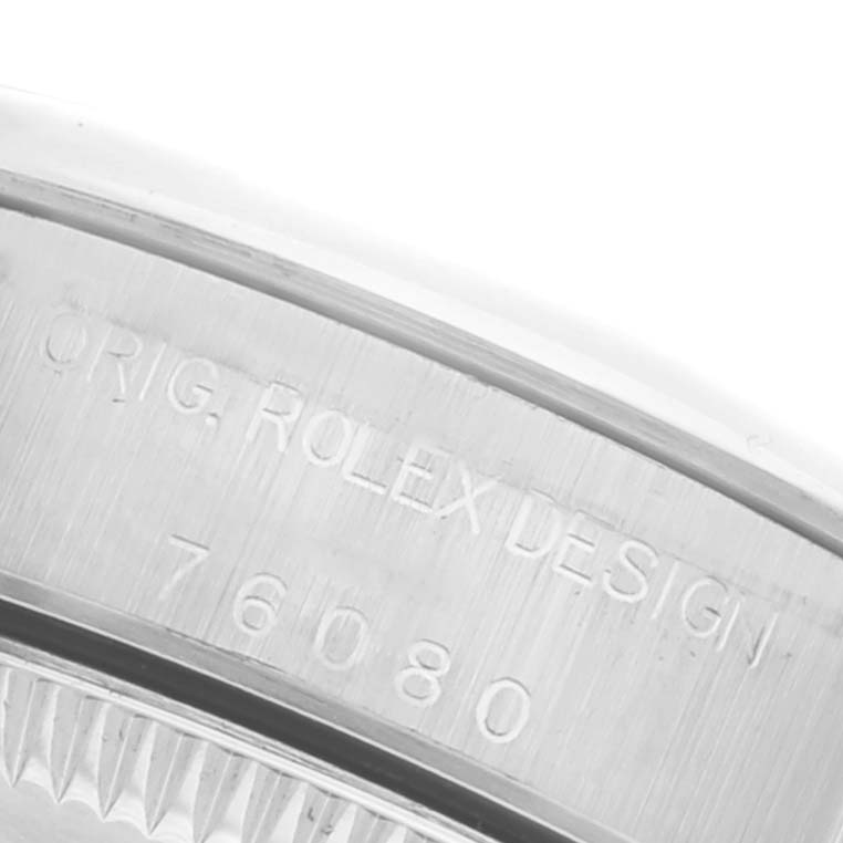 The image shows a close-up of the side of a Rolex Oyster Perpetual 76080 Women's Stainless Steel Black Dial 76080 Women's Stainless Steel Black Dial watch, highlighting the engraved model number.