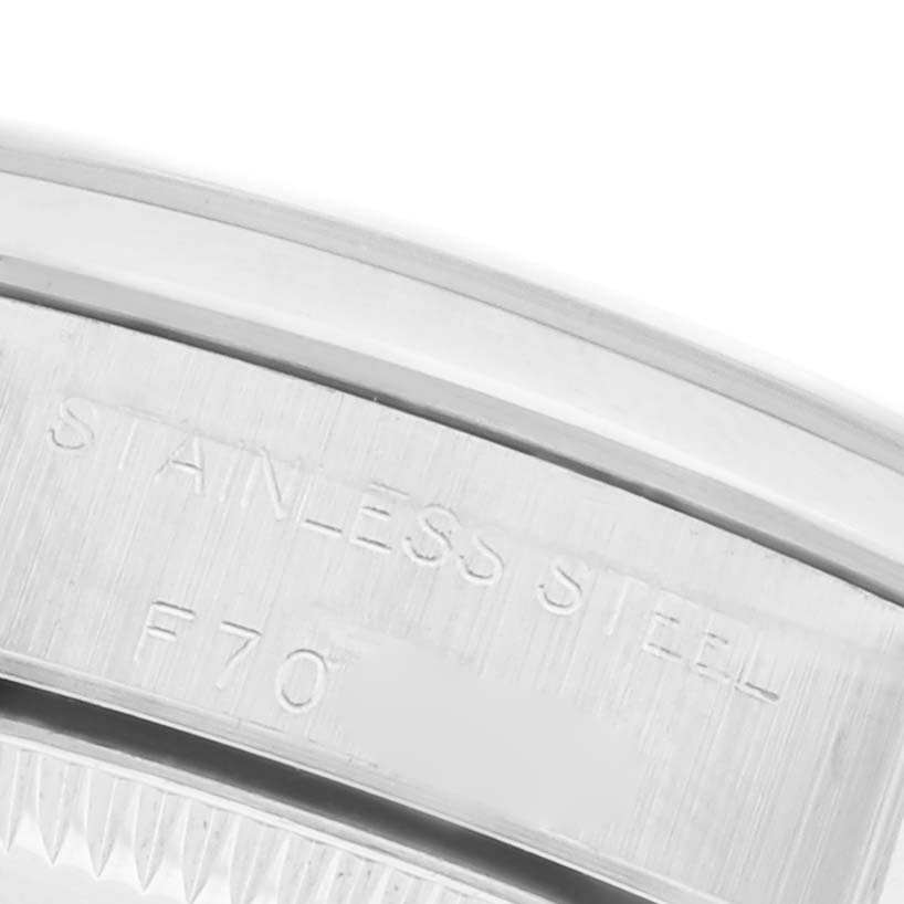 The image shows a close-up of the stainless steel case back edge of a Rolex Oyster Perpetual 76080 Women's Stainless Steel Black Dial 76080 Women's Stainless Steel Black Dial watch.
