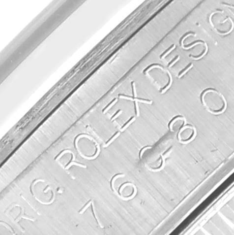 The image shows a close-up of the Oyster Perpetual Rolex watch's inner case, highlighting engraved details.