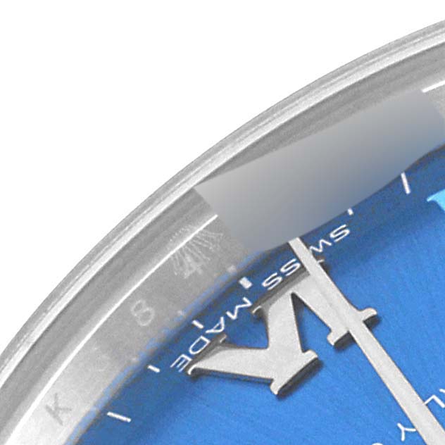 This close-up image shows the dial and part of the bezel of a Mid-Size Rolex watch.