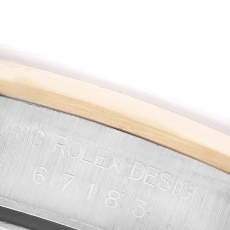 The image shows a close-up of the Rolex Oyster Perpetual 67183 Women's Steel and Gold (two tone) Champagne Dial 67183 Women's Steel and Gold (two tone) Champagne Dial's bezel and engraved serial number on the case side.