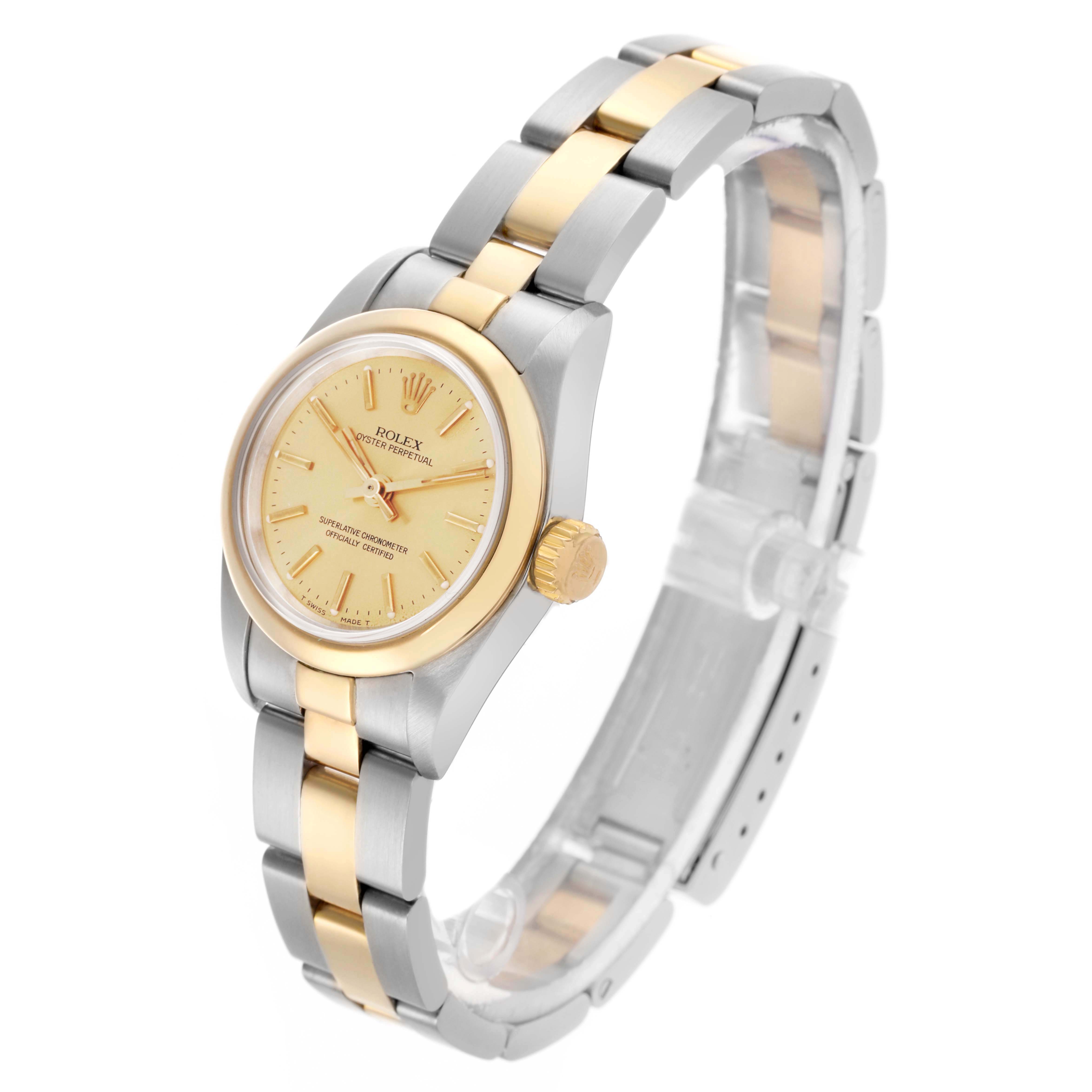 The Rolex Oyster Perpetual 67183 Women's Steel and Gold (two tone) Champagne Dial 67183 Women's Steel and Gold (two tone) Champagne Dial watch is shown at an angled side view, displaying the face, bezel, crown, and bracelet.