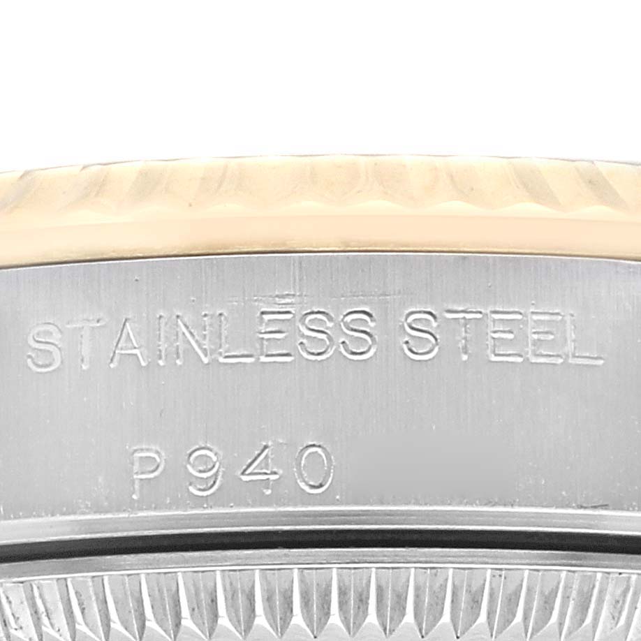 This close-up image shows the side of a Rolex Oyster Perpetual 76193 Women's Steel and Gold (two tone) White Dial 76193 Women's Steel and Gold (two tone) White Dial, highlighting the "STAINLESS STEEL" inscription and serial number.