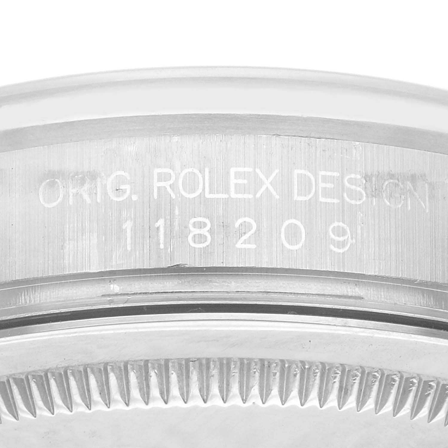 The image shows a close-up view of the model number engraving on the side of the bezel of a Rolex President 118209 Men's White Gold Silver Dial 118209 Men's White Gold Silver Dial watch.