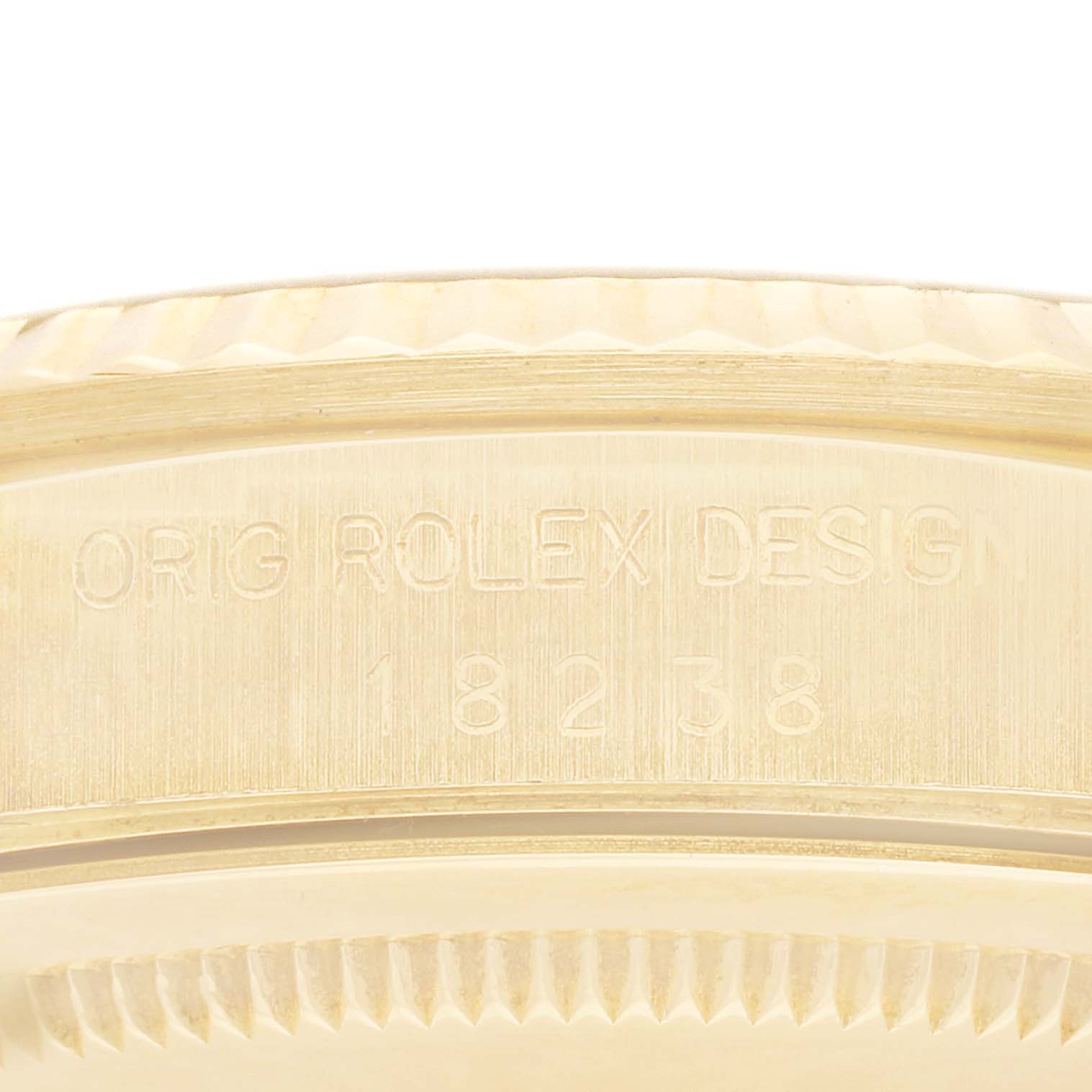 This close-up image shows the side engraving and part of the bezel of a Rolex President 18238 Men
s Yellow Gold Champagne Dial 18238 Men
s Yellow Gold Champagne Dial model watch.