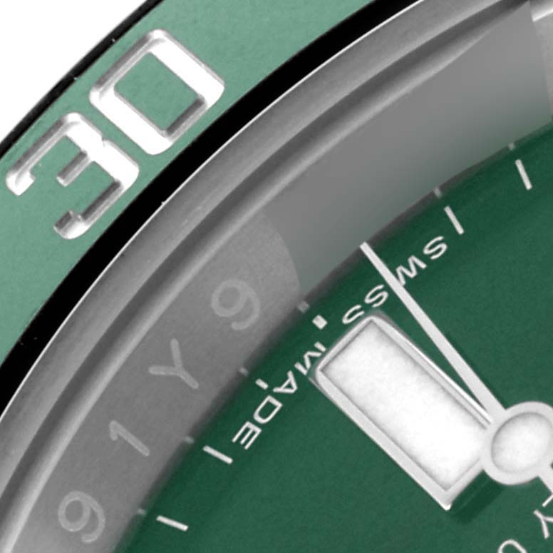 The image shows a close-up of a Rolex Submariner 116610LV Men's Stainless Steel Green Dial 116610LV Men's Stainless Steel Green Dial watch focused on the green bezel and part of the dial, including the minute markers and "Swiss Made" text.