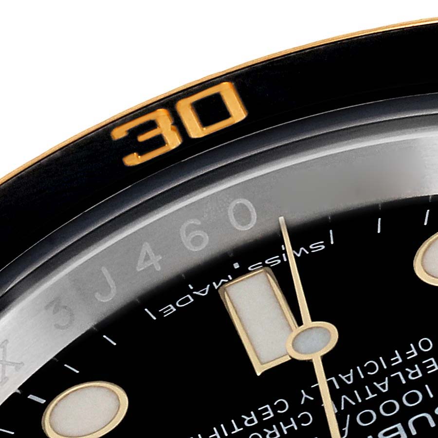This close-up image of a Rolex Submariner 116613 Men's Steel and Gold (two tone) Black Dial 116613 Men's Steel and Gold (two tone) Black Dial watch shows the bezel with the "30" marker, part of the dial, and the minute hand.