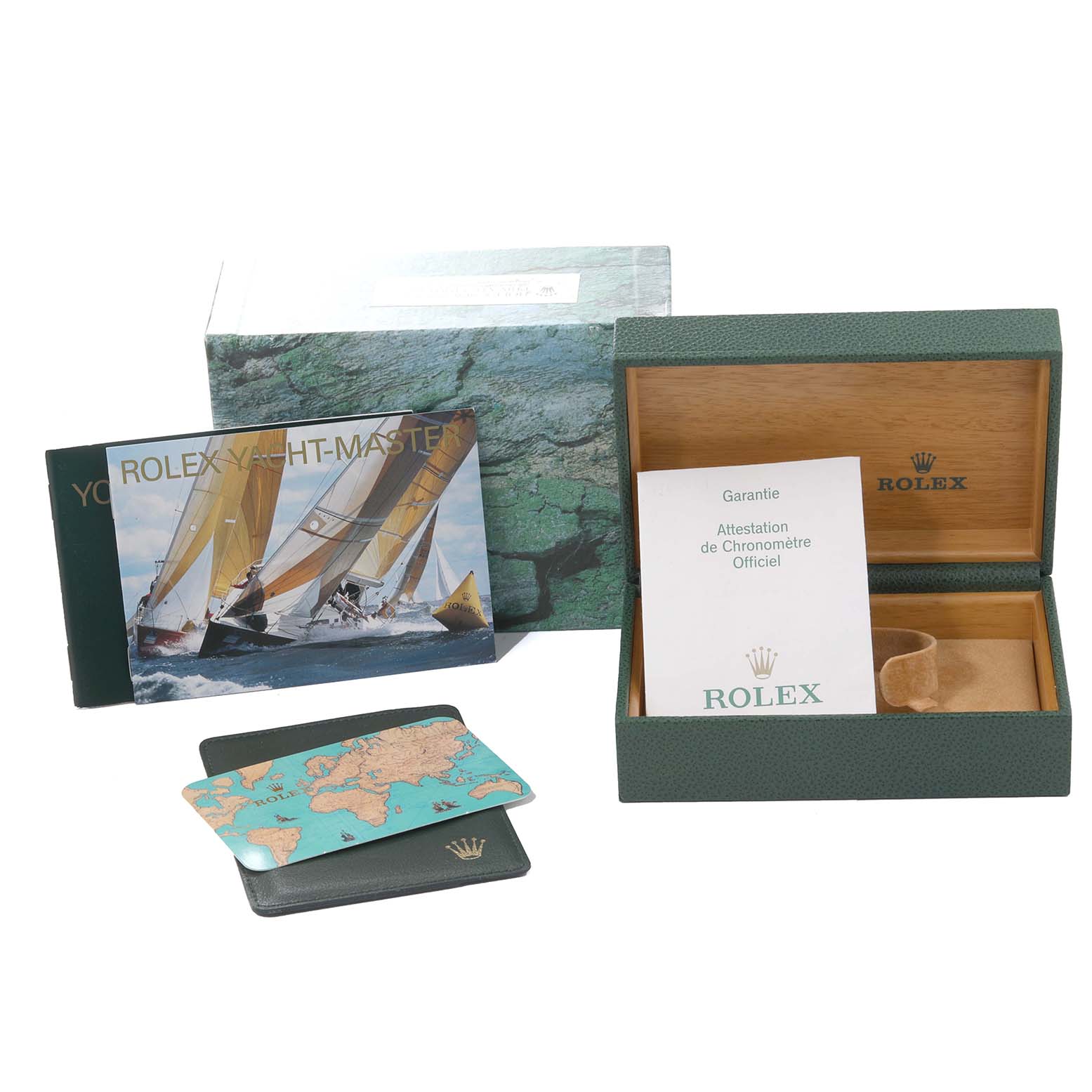 The image shows an open Rolex Yacht-Master 169622 Women
s Stainless Steel Silver Dial 169622 Women
s Stainless Steel Silver Dial box, a warranty card, a booklet, and a world map card holder.