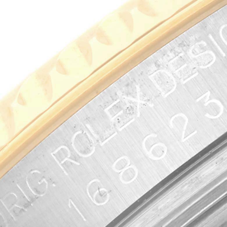 This close-up image shows part of the engraved outer rim of a Rolex Yacht-Master 168623 Men's Steel and Gold (two tone) Grey Dial 168623 Men's Steel and Gold (two tone) Grey Dial watch.