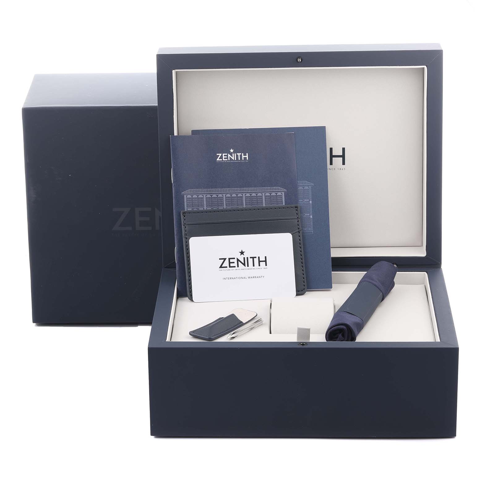 The image shows a Zenith Chronomaster 03.3400.3610/39.M3200 Men
s Stainless Steel Grey Dial 03.3400.3610/39.M3200 Men
s Stainless Steel Grey Dial watch box containing manuals, a cardholder, and a cloth, viewed from the front angle.