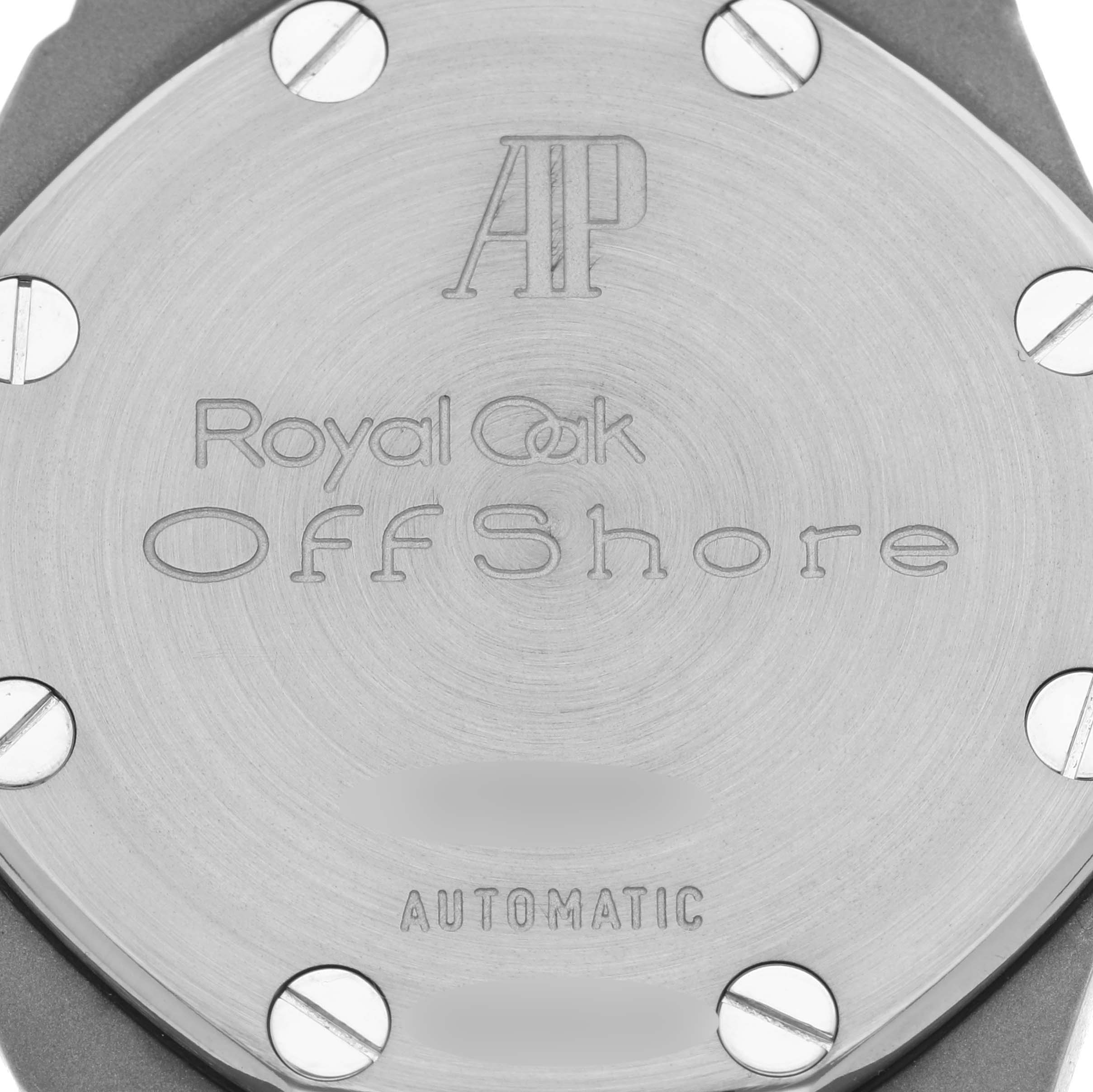 The image shows the back case of a Royal Oak Offshore by Audemars Piguet, revealing engraved branding and screws.