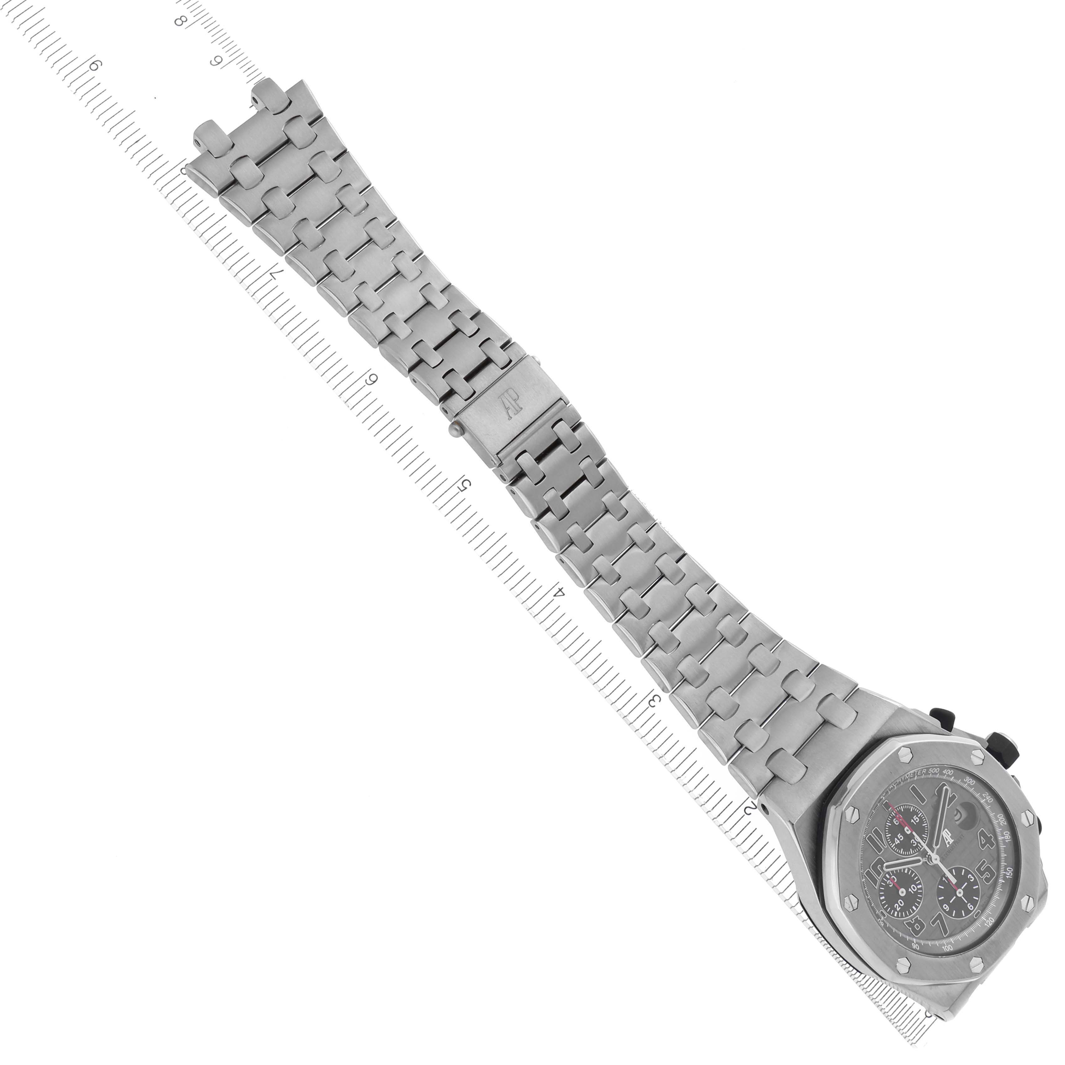 The Audemars Piguet Royal Oak Offshore 26170TI.OO.1000TI.01 Men's Titanium Grey Dial 26170TI.OO.1000TI.01 Men's Titanium Grey Dial watch is shown at a top-down angle, displaying the face and full metal bracelet alongside a ruler.