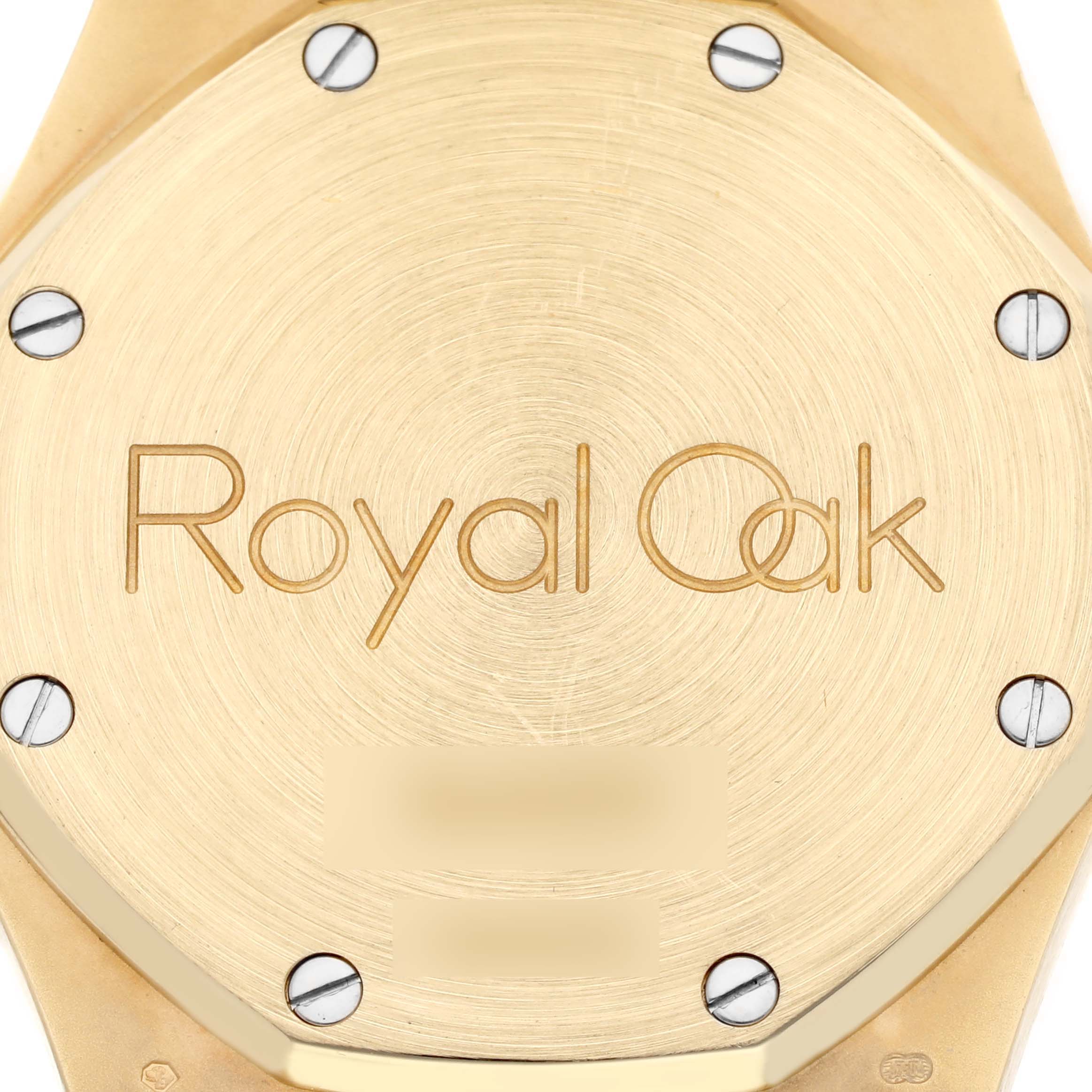 The image shows the back case of an Audemars Piguet Royal Oak 25960BA.OO.1185BA.01 Men's Yellow Gold White Dial 25960BA.OO.1185BA.01 Men's Yellow Gold White Dial watch with visible screws and the model name engraved.