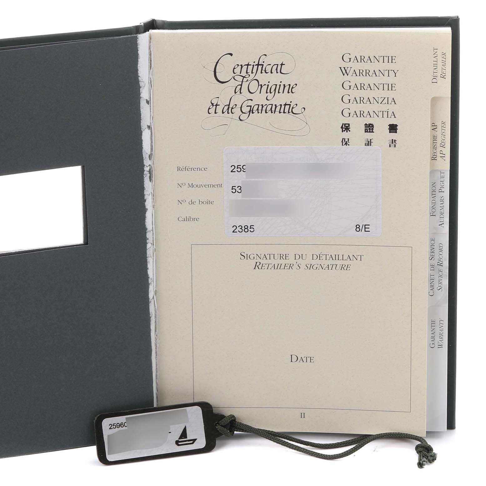 The image shows the warranty booklet and a tag for the Audemars Piguet Royal Oak 25960BA.OO.1185BA.01 Men's Yellow Gold White Dial 25960BA.OO.1185BA.01 Men's Yellow Gold White Dial model.