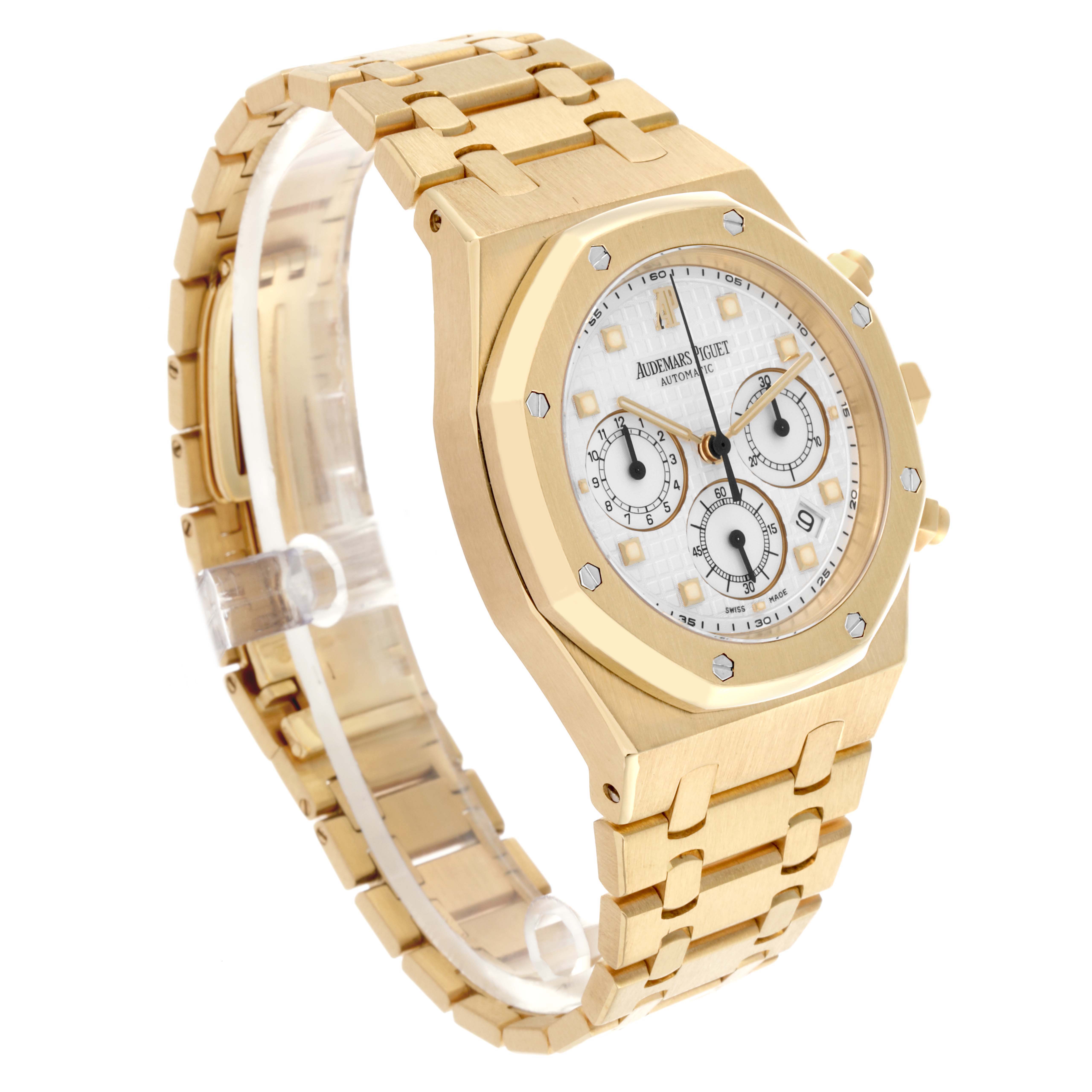 The Audemars Piguet Royal Oak 25960BA.OO.1185BA.01 Men's Yellow Gold White Dial 25960BA.OO.1185BA.01 Men's Yellow Gold White Dial watch is shown at a three-quarter angle displaying its face, bezel, chronograph subdials, and bracelet.