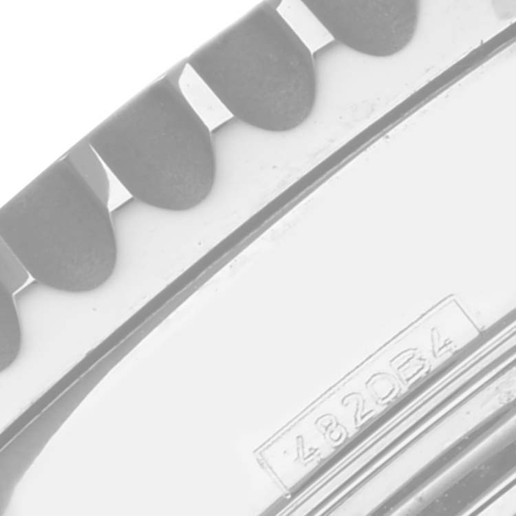 The image shows a close-up of the bezel and part of the case back of a Navitimer model by Breitling, highlighting the notches and an engraved number.