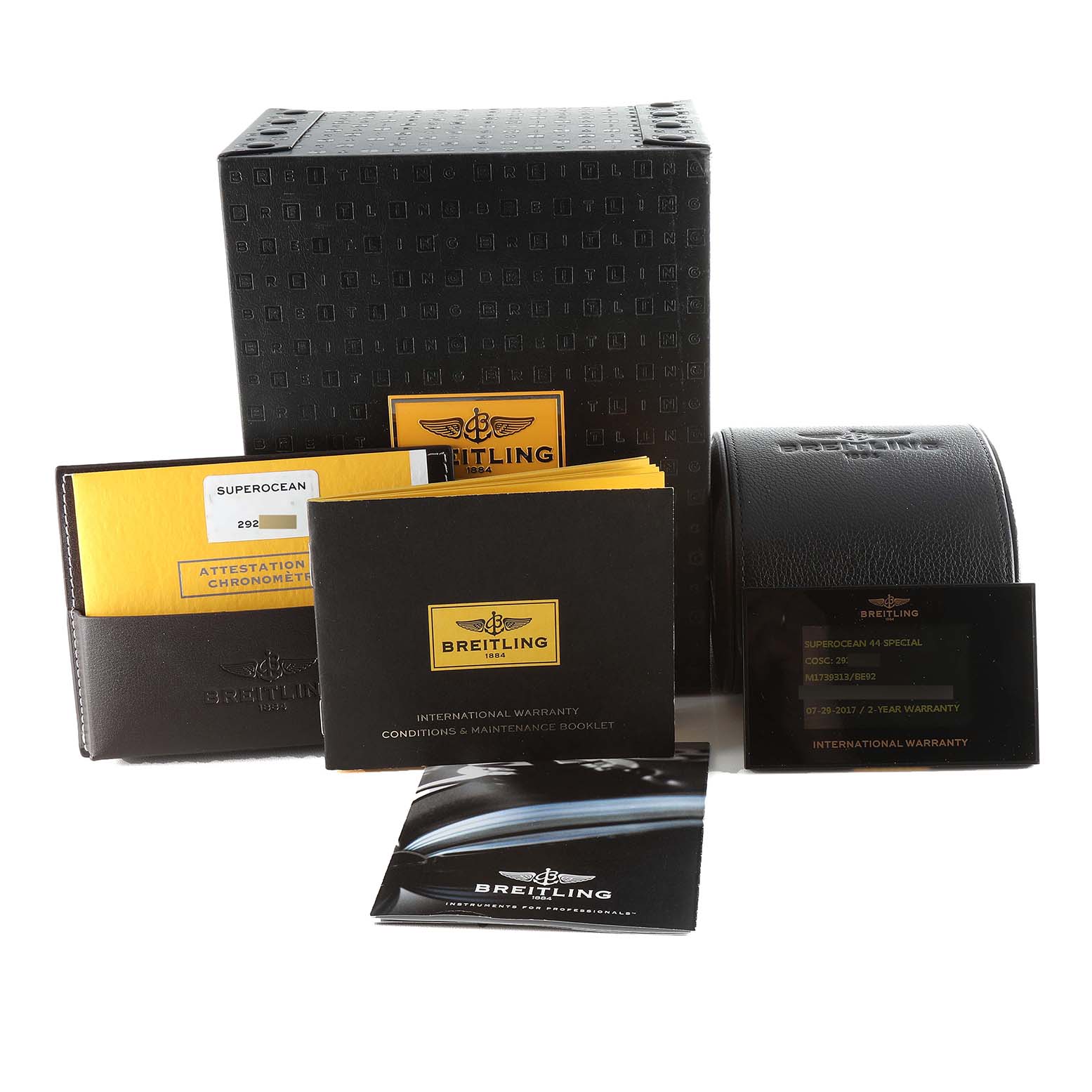 This image shows the packaging and accessories for the Breitling Superocean M17393 Men's Stainless Steel Black Dial M17393 Men's Stainless Steel Black Dial model including the box, warranty cards, and manuals.