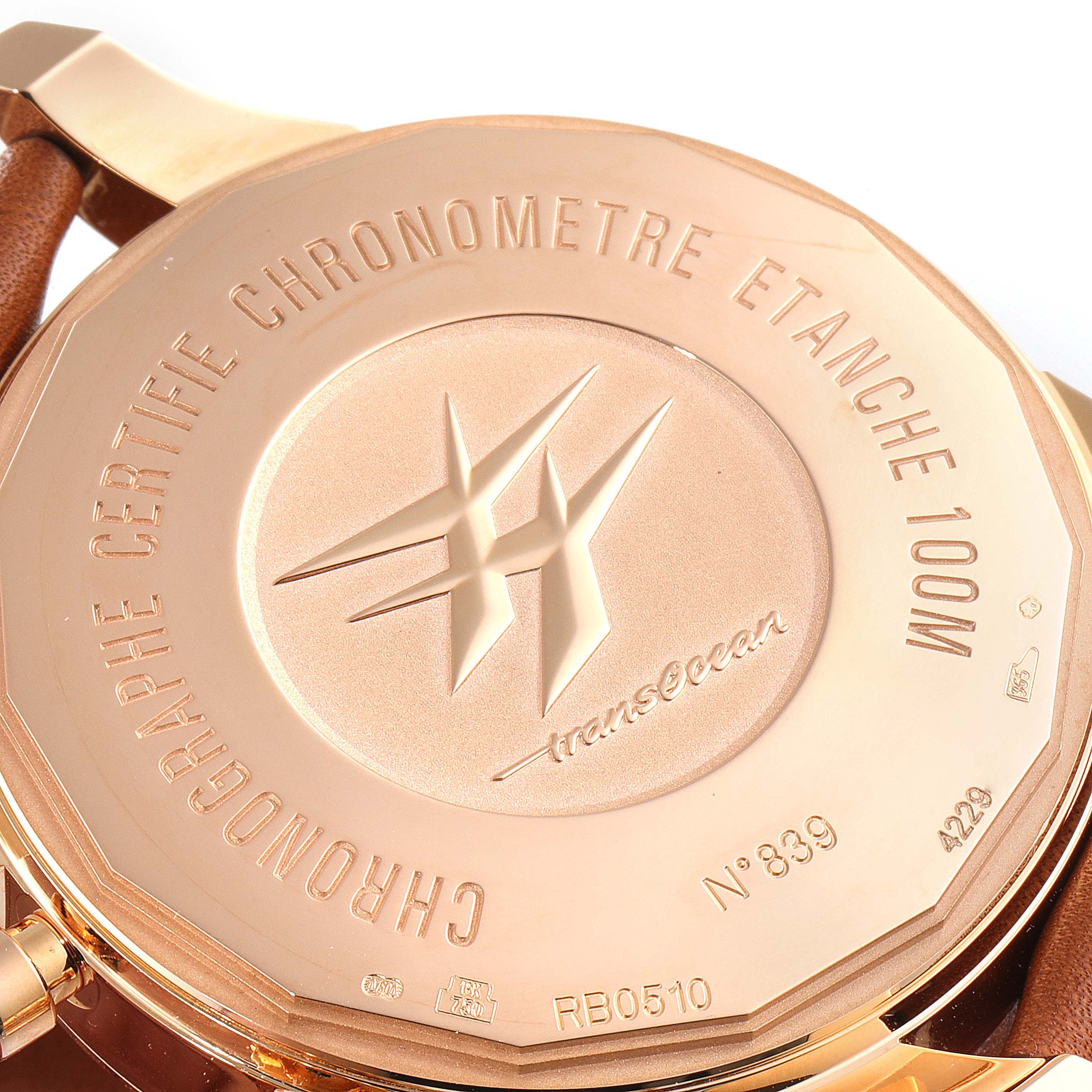 The image shows the back of a Breitling Transocean RB0510U4-BB63BKLD Men's Rose Gold White Dial RB0510U4-BB63BKLD Men's Rose Gold White Dial watch, including the case back with engravings.