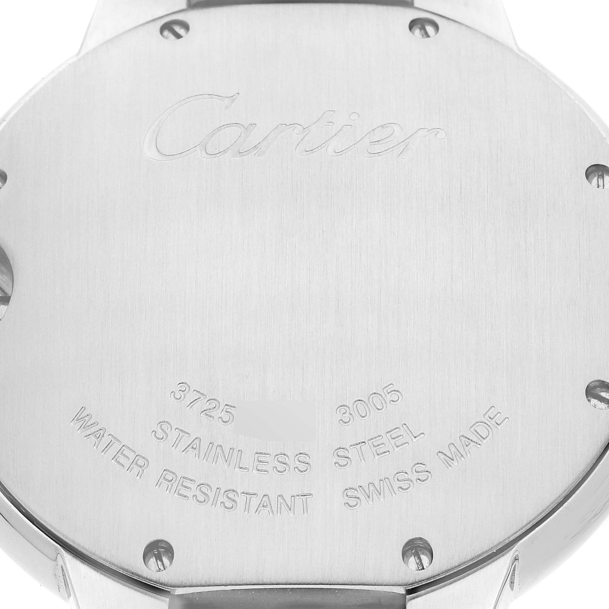 The image shows the stainless steel back case of the Ballon Bleu watch by Cartier, with engravings and screws visible.