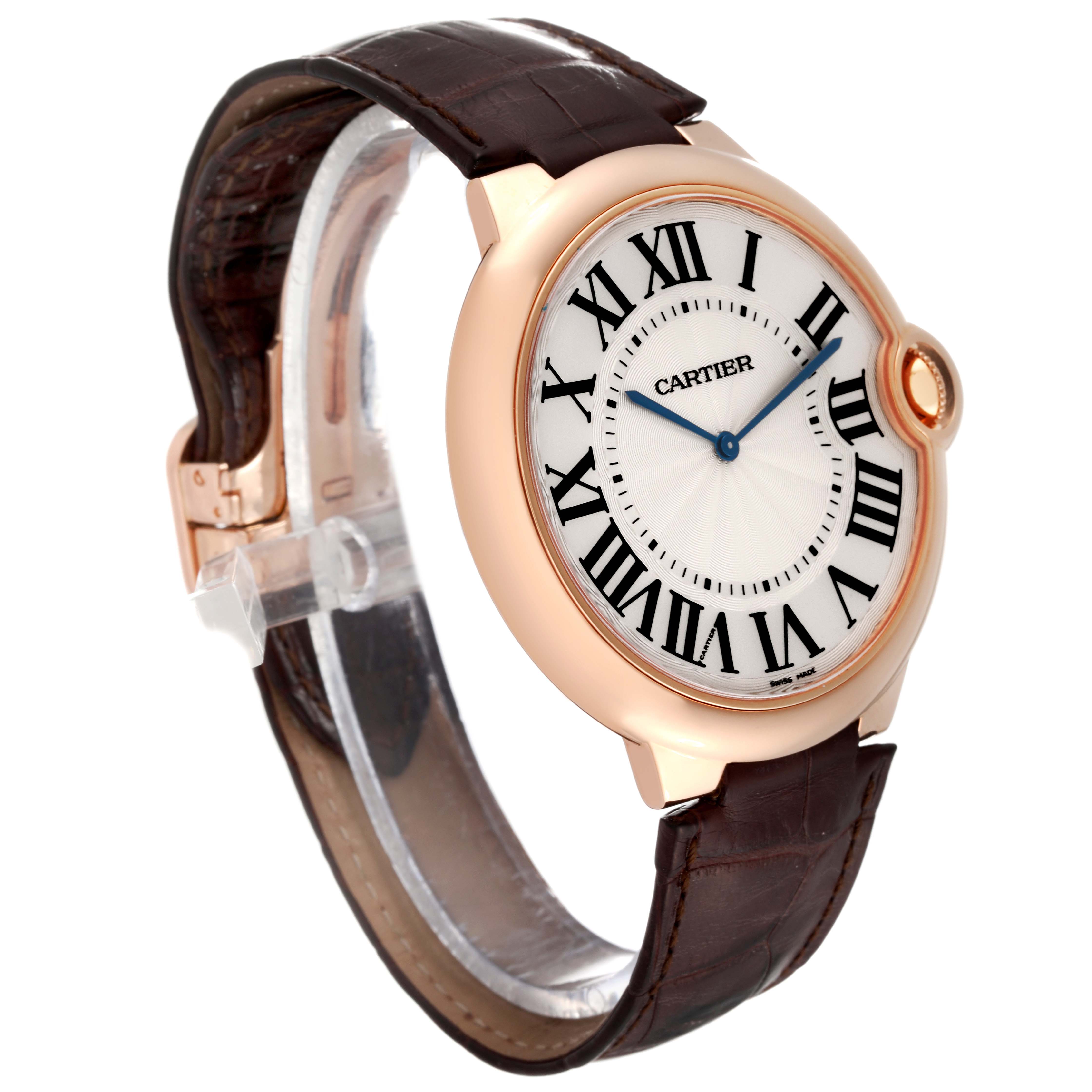 The image shows the Cartier Ballon Bleu W6920054 Men
s Rose Gold Silver Dial W6920054 Men
s Rose Gold Silver Dial watch at a three-quarter angle, displaying its face, Roman numerals, leather strap, and crown.