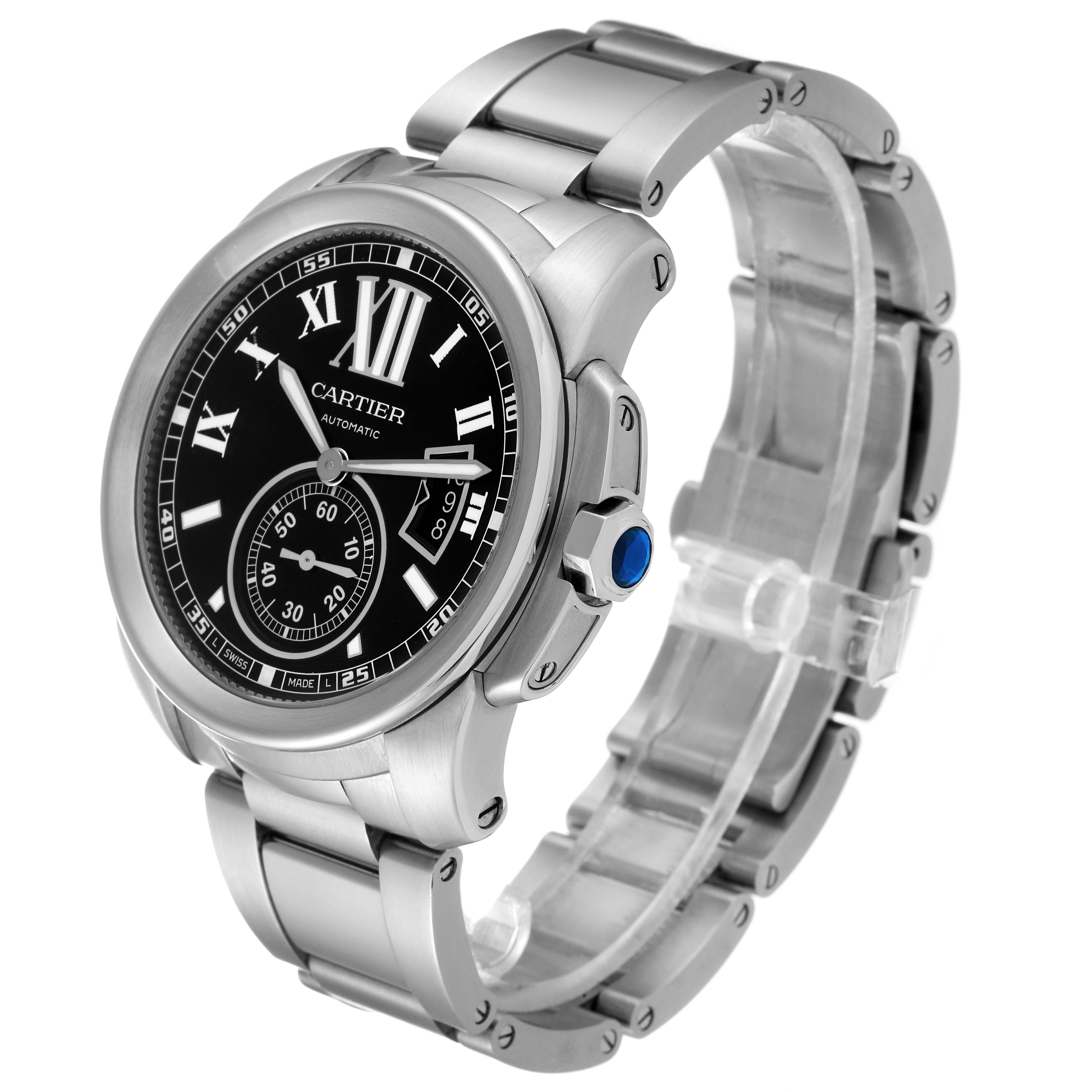 The Calibre de Cartier watch by Cartier is shown at a three-quarter angle, highlighting its black dial, Roman numerals, and metal bracelet.