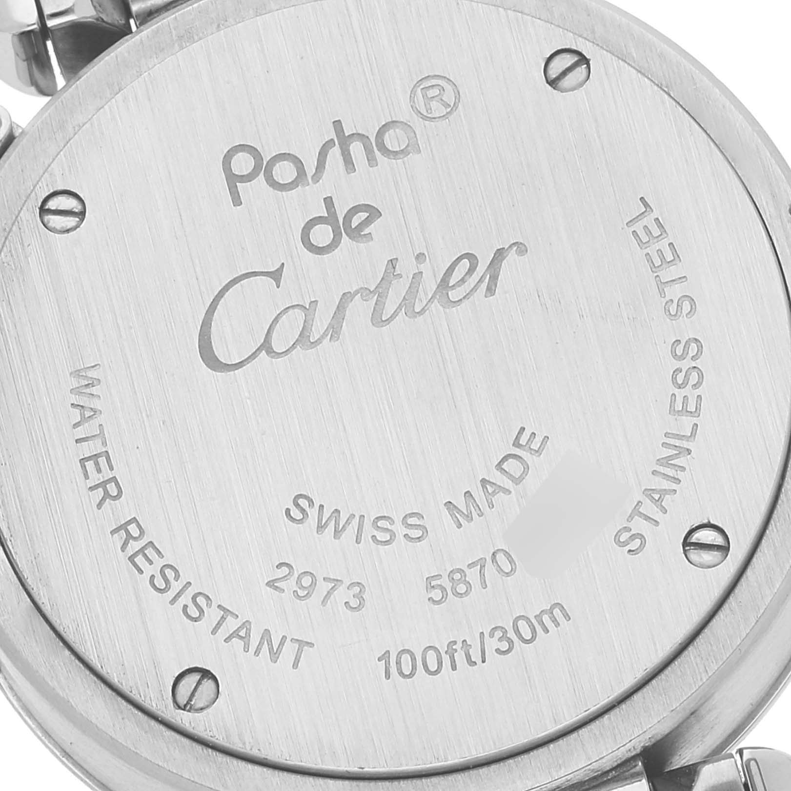 The image shows the back casing of a Pasha de Cartier watch, highlighting its engravings and stainless steel material.