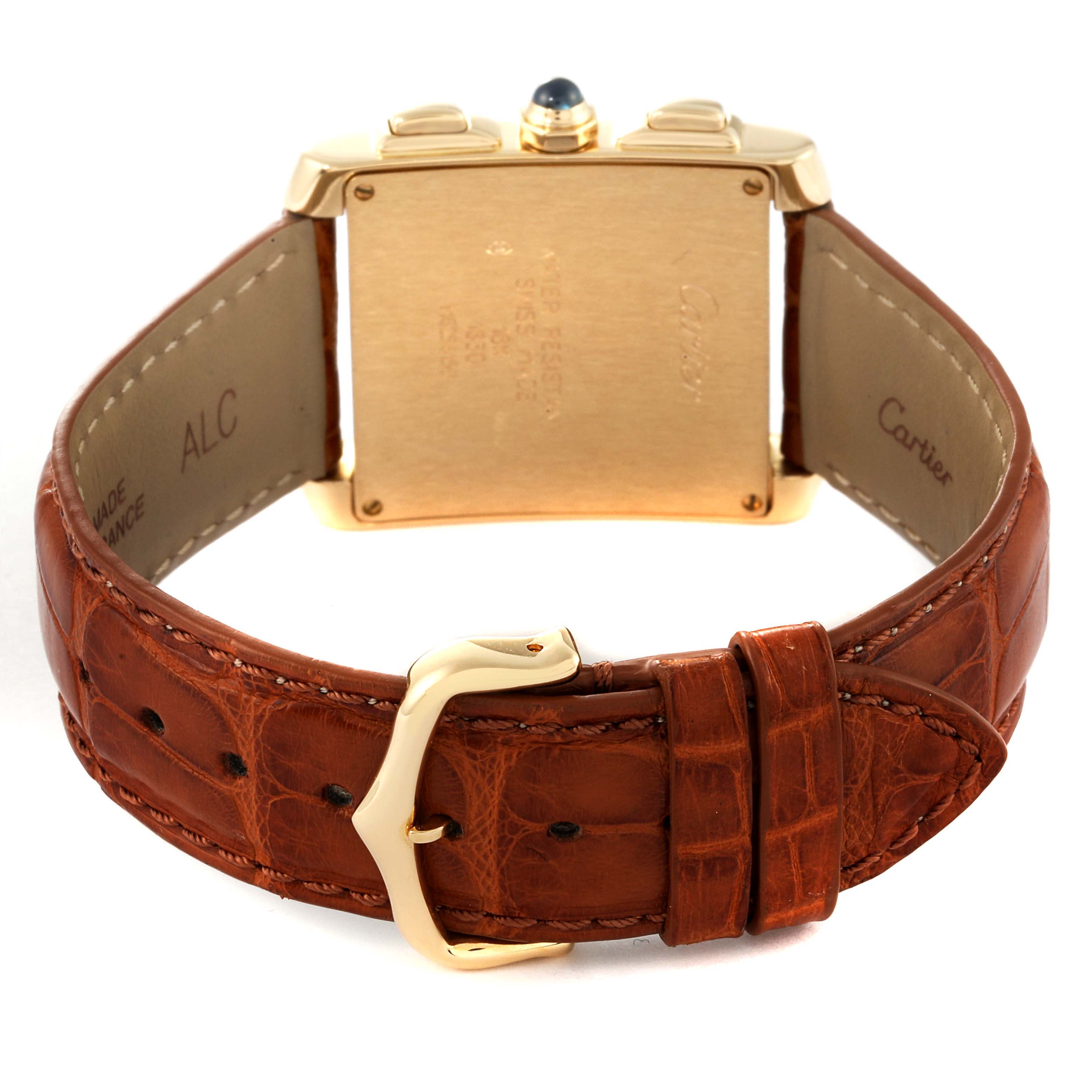 The image shows the back view of a Cartier Tank Francaise W5000556 Men's Yellow Gold Silver Dial W5000556 Men's Yellow Gold Silver Dial watch with a brown leather strap and gold buckle.