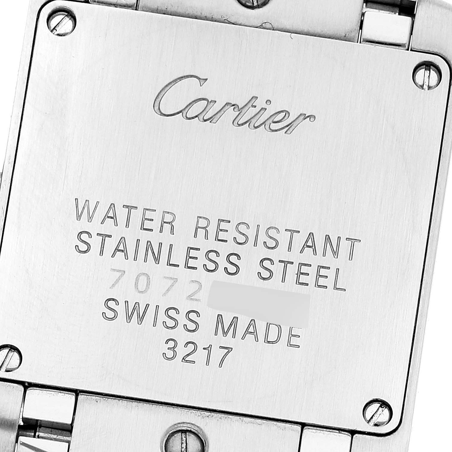 The image shows the back case of a Cartier Tank Française watch, displaying engravings about its material and water resistance.