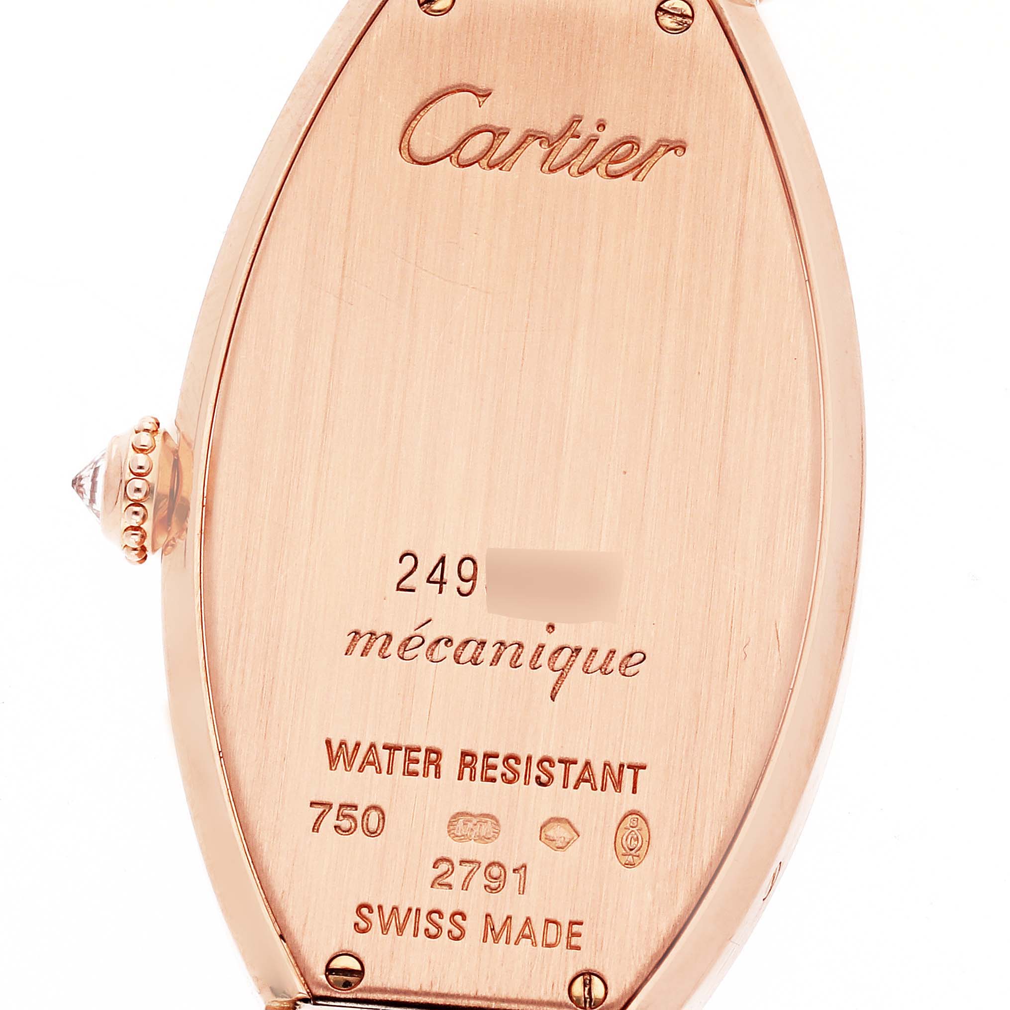 This image shows the back case of the Tonneau model watch by Cartier from a close-up angle, highlighting the inscriptions and details.