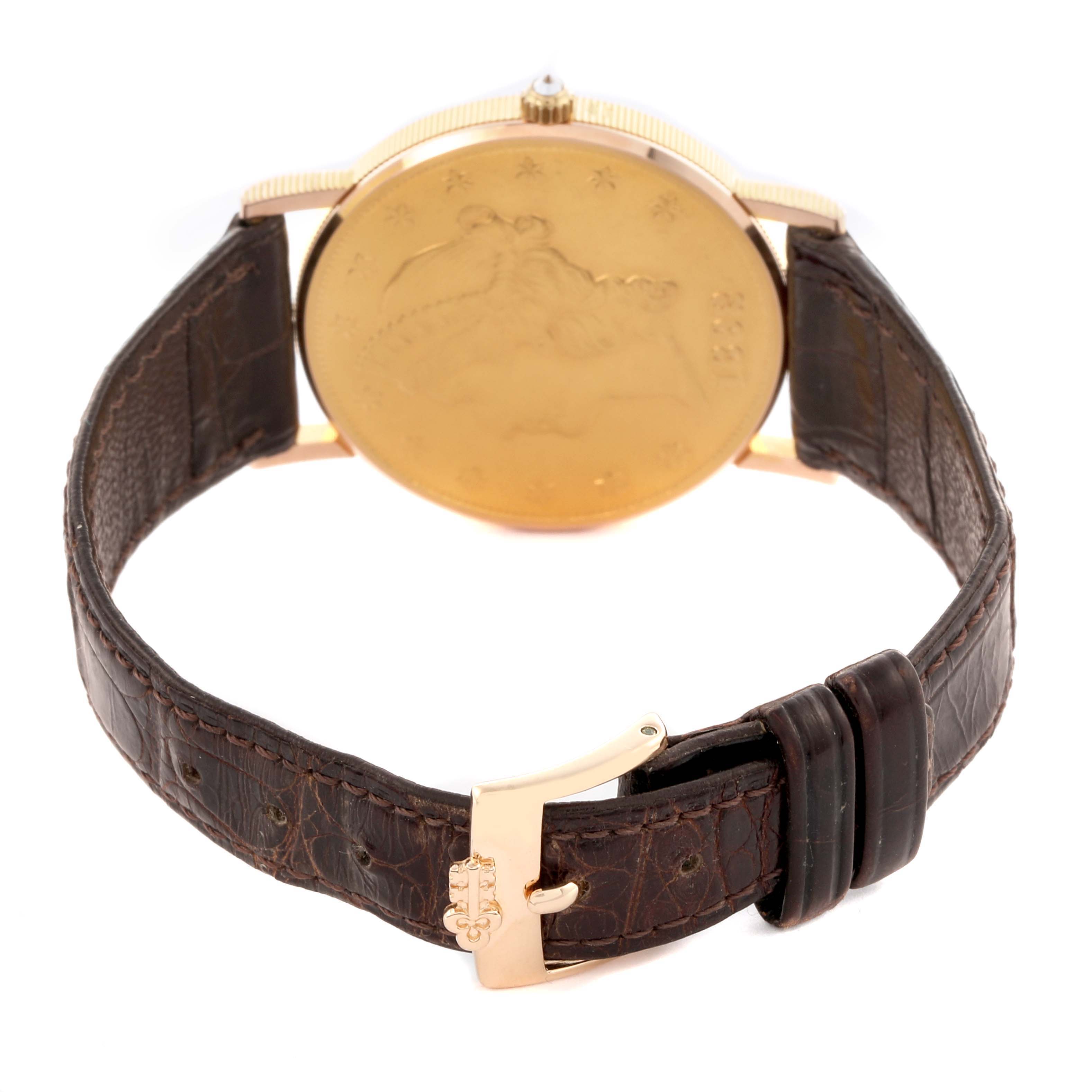 The Corum Coin Watch 4414556 Men's Yellow Gold Champagne Dial 4414556 Men's Yellow Gold Champagne Dial is shown from the back, highlighting its coin-like case and leather strap.