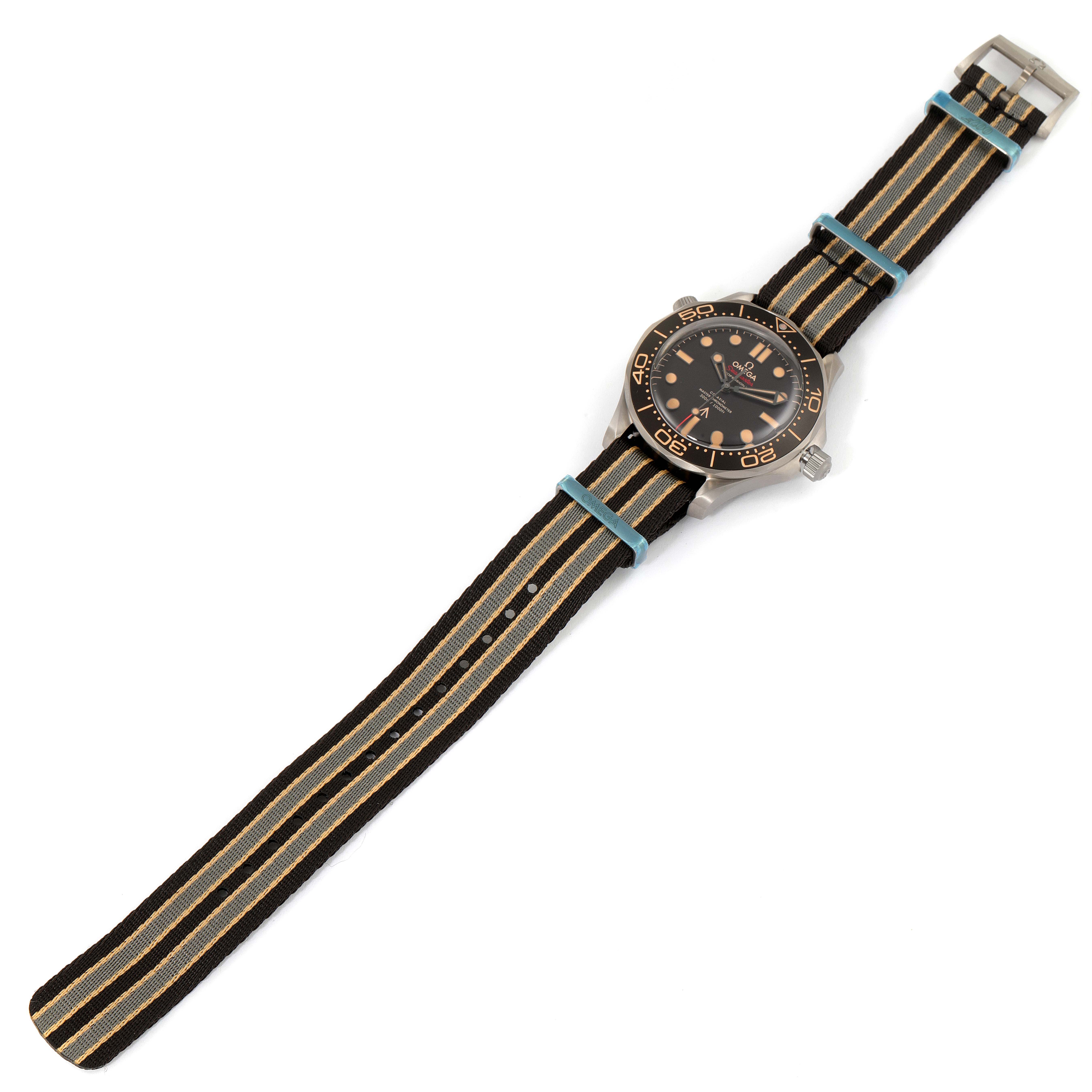 The image shows an Omega Seamaster 210.92.42.20.01.001 Men's Titanium Brown Dial 210.92.42.20.01.001 Men's Titanium Brown Dial watch from a top-down angle, highlighting its face and striped NATO strap.